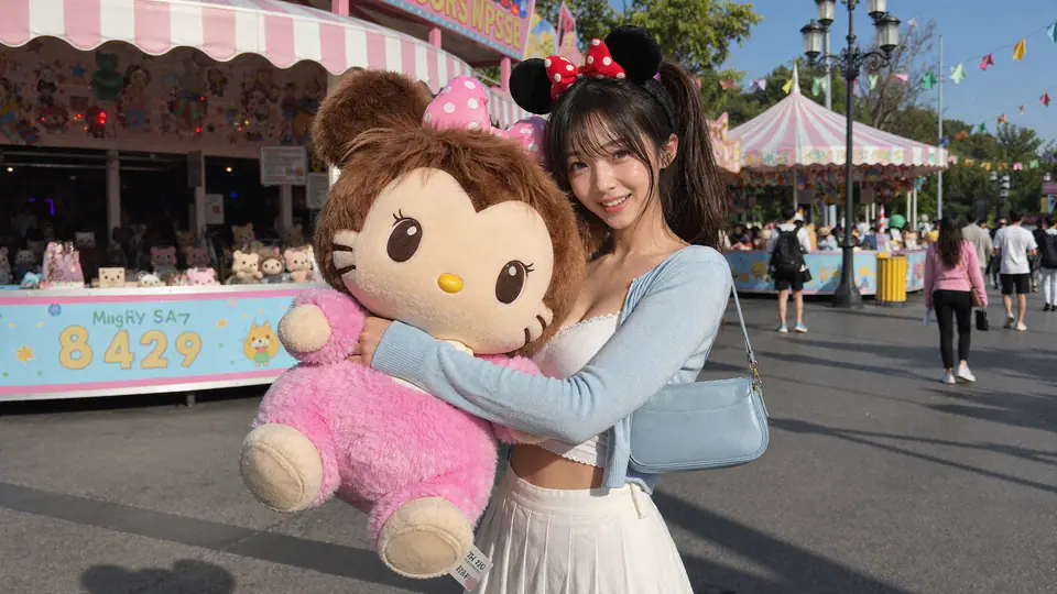Riho at a fair holding a large plush